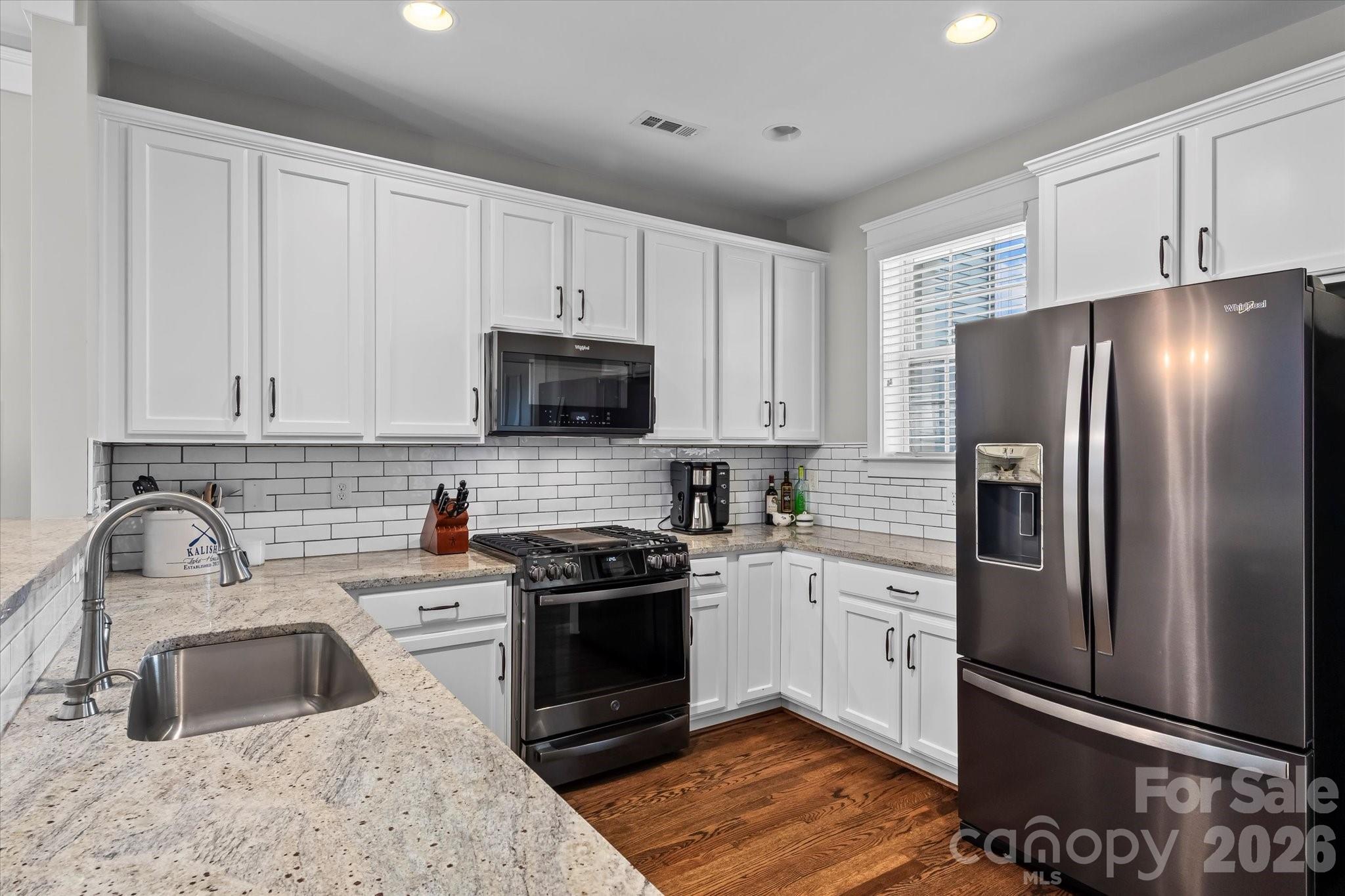 301 Bridges Farm Road Mooresville, NC 28115 - Photo 14 of 46 a kitchen with stainless steel appliances granite countertop a refrigerator sink and stove