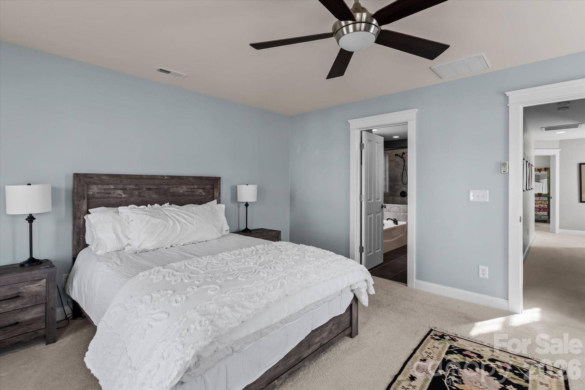 301 Bridges Farm Road Mooresville, NC 28115 - Photo 24 of 46 a bedroom with a bed and a chandelier