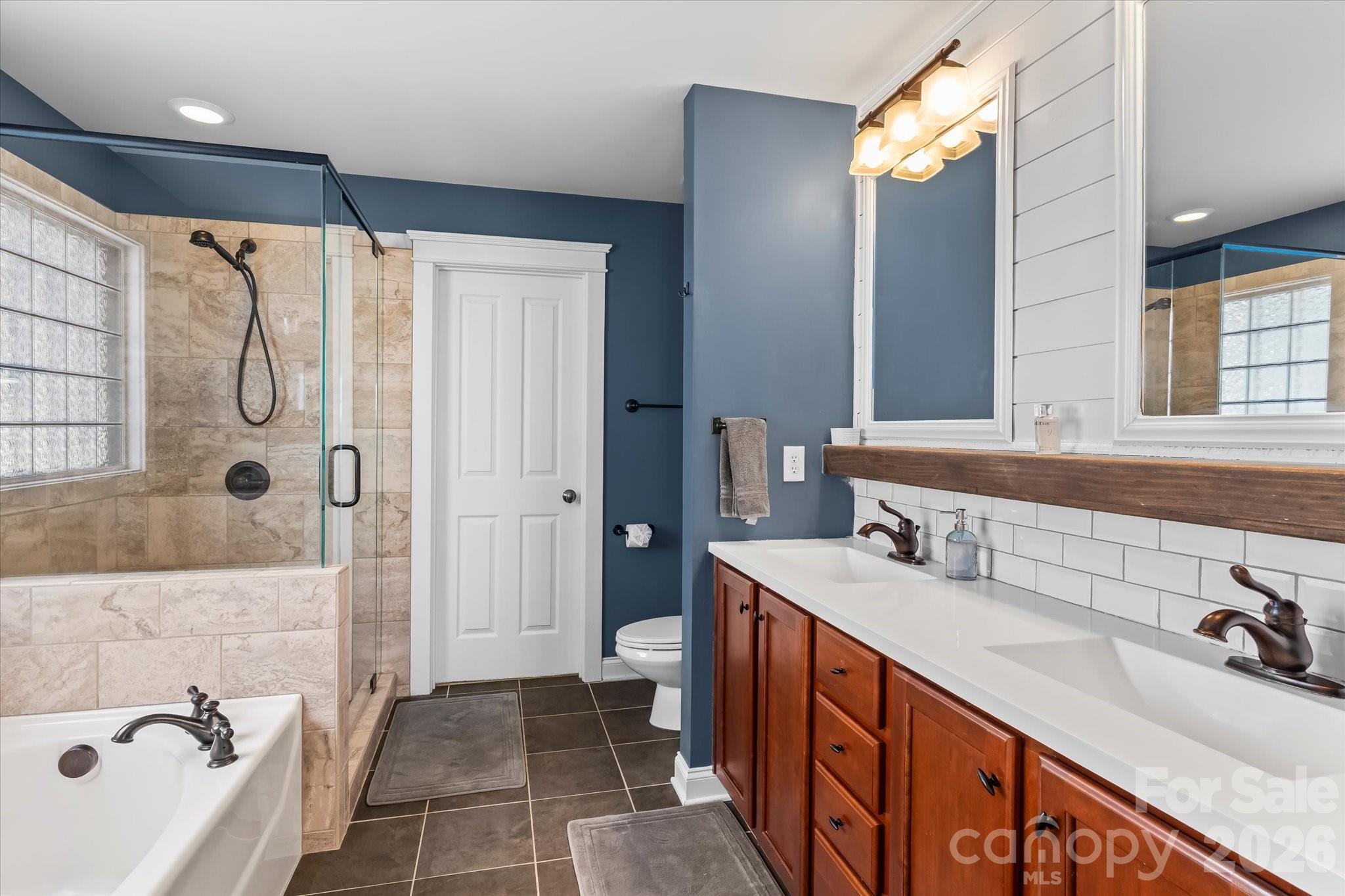 301 Bridges Farm Road Mooresville, NC 28115 - Photo 27 of 46 a bathroom with a tub sink and mirror