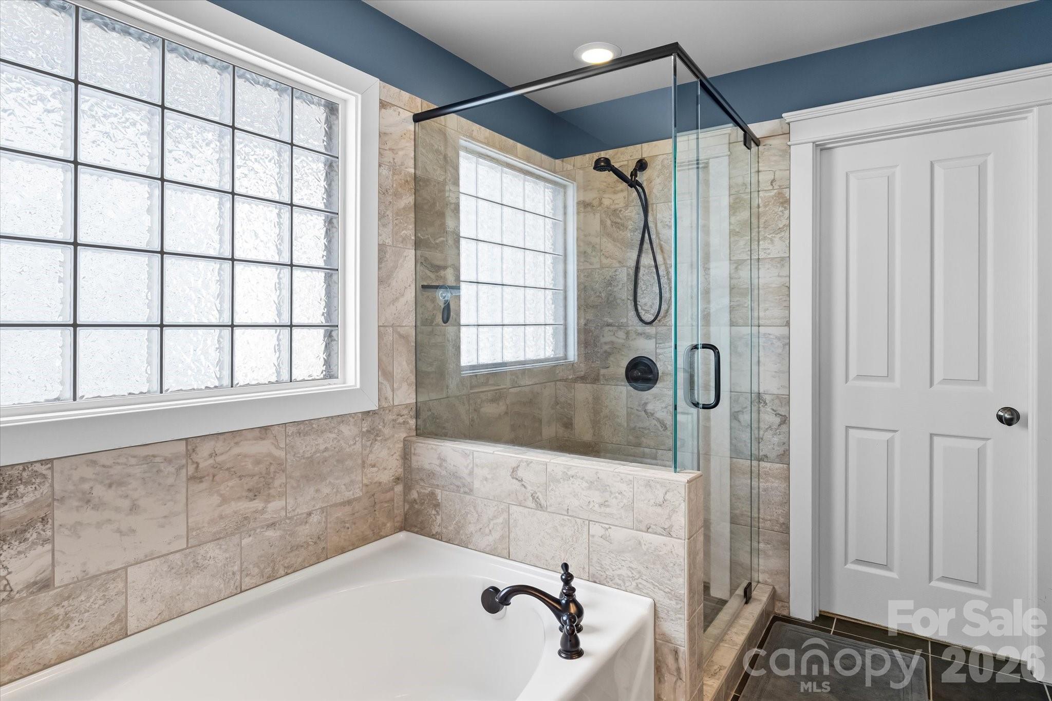 301 Bridges Farm Road Mooresville, NC 28115 - Photo 28 of 46 a bathroom with a bathtub and a shower