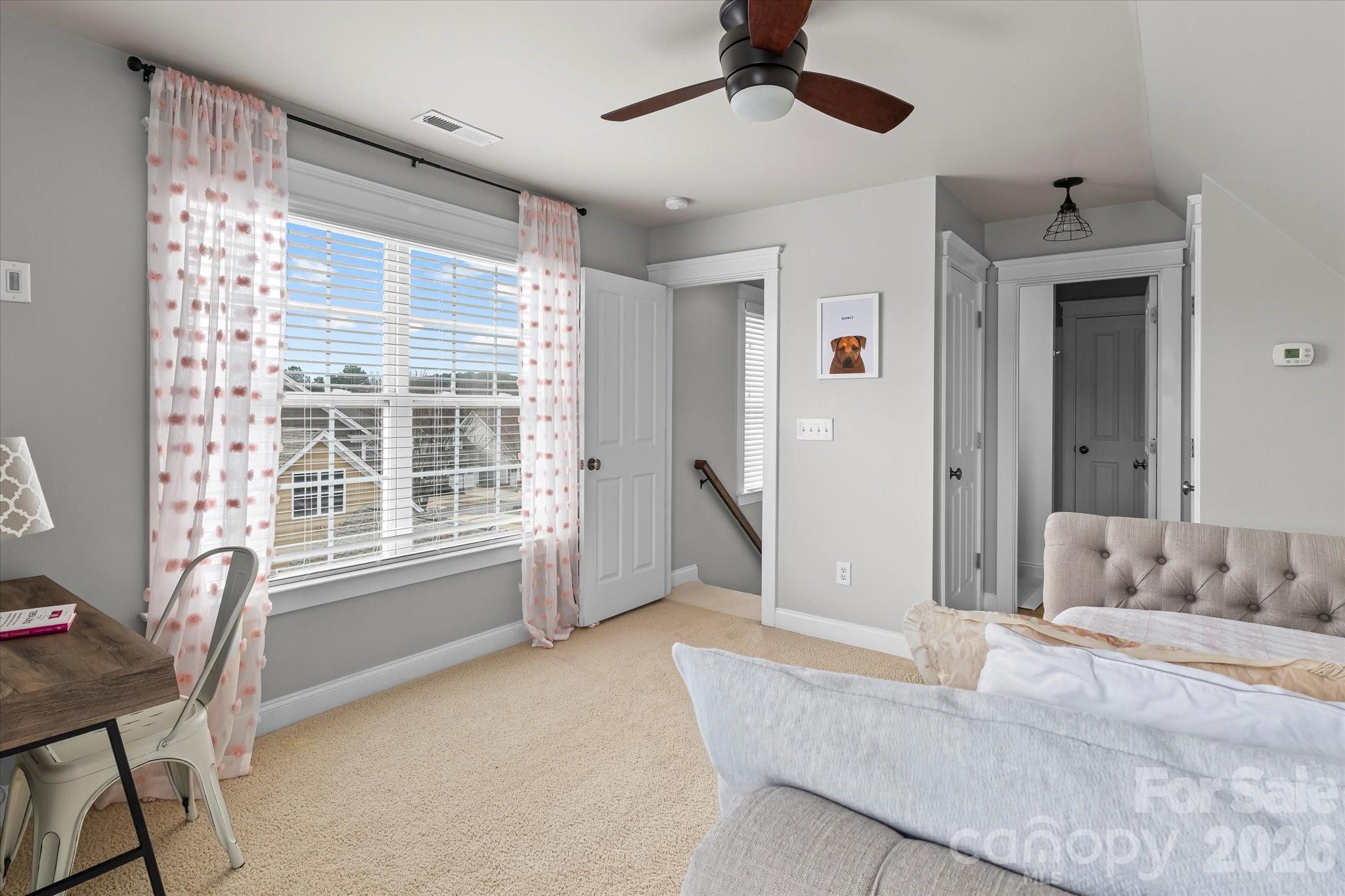 301 Bridges Farm Road Mooresville, NC 28115 - Photo 33 of 46 a spacious bedroom with a large bed and a chandelier