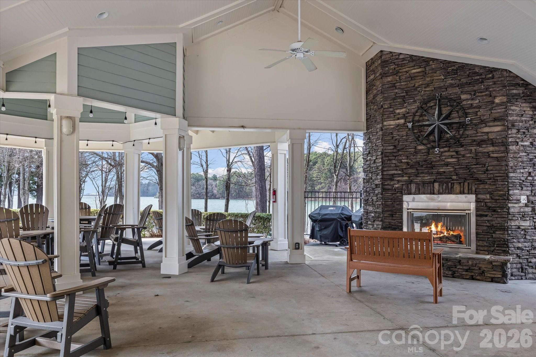 301 Bridges Farm Road Mooresville, NC 28115 - Photo 39 of 46 a living room with furniture a fireplace and a floor to ceiling window