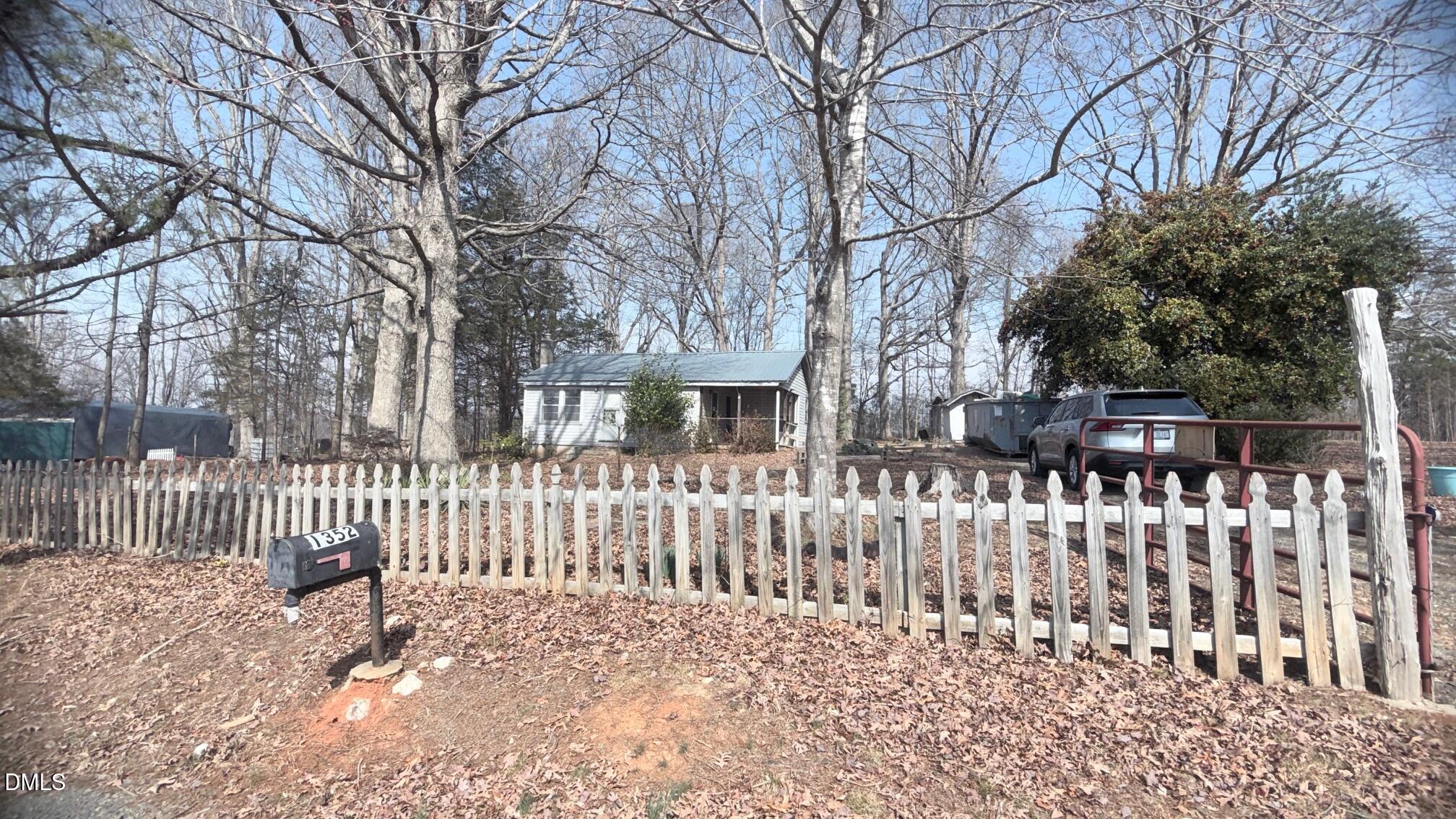 1352 Seays Road Liberty, NC 27298 - Photo 1 of 19 a view of a house with wooden fence