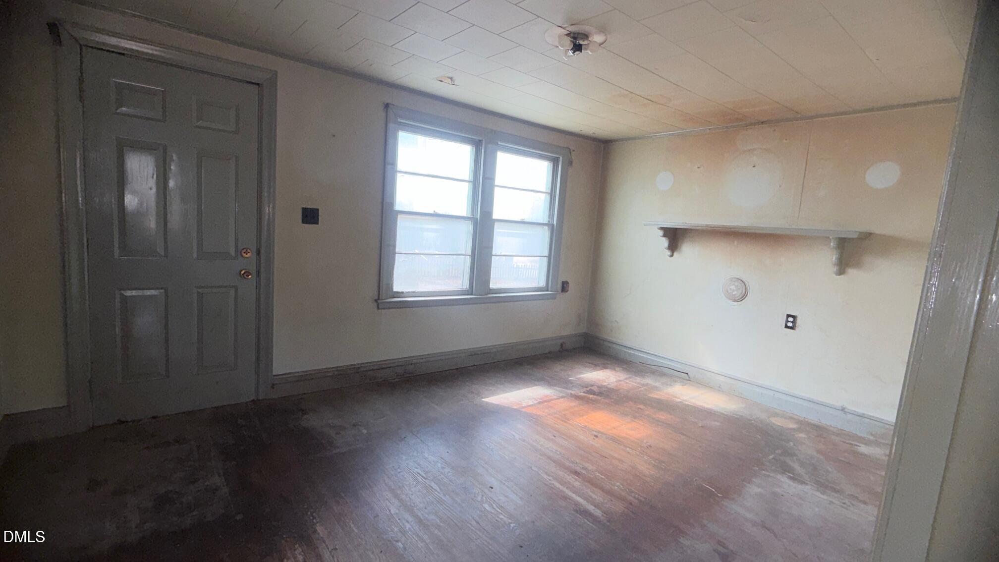 1352 Seays Road Liberty, NC 27298 - Photo 11 of 19 an empty room with wooden floor and windows