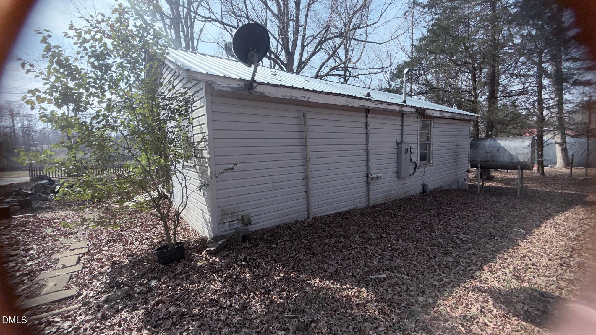1352 Seays Road Liberty, NC 27298 - Photo 18 of 19 a backyard of a house with large trees and wooden fence