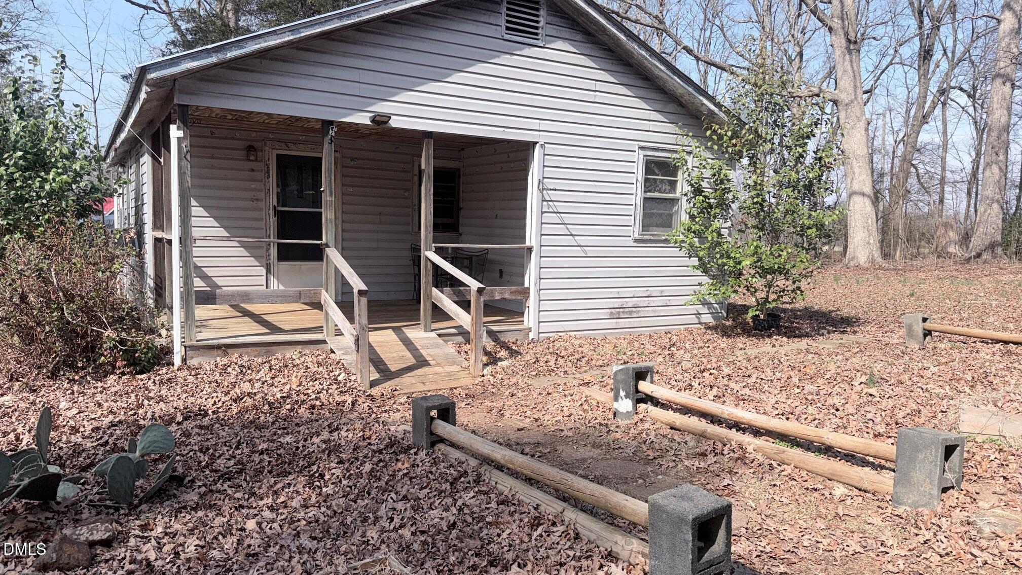 1352 Seays Road Liberty, NC 27298 - Photo 4 of 19 a wooden bench sitting in front of a house