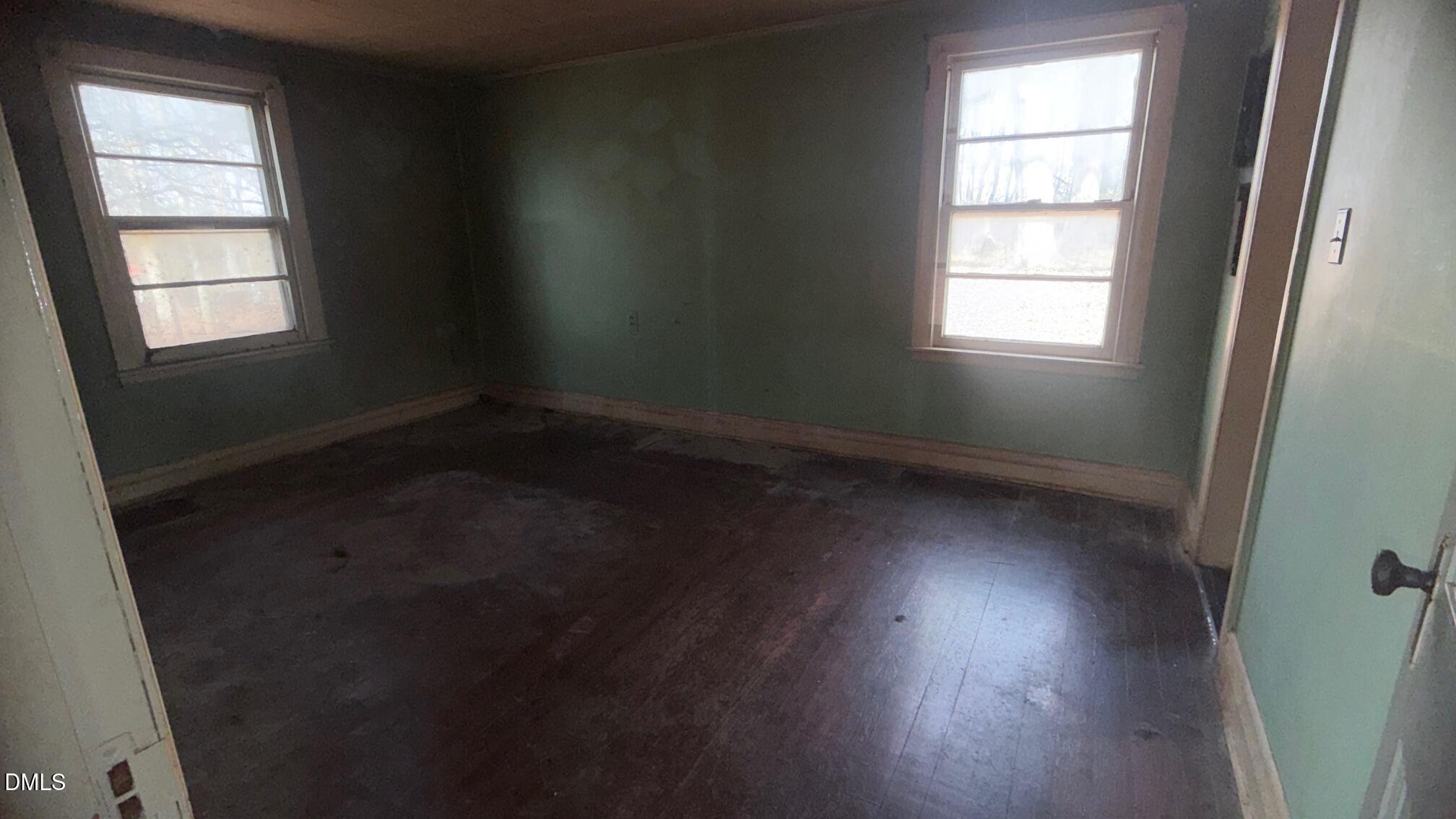 1352 Seays Road Liberty, NC 27298 - Photo 10 of 19 an empty room with wooden floor and windows