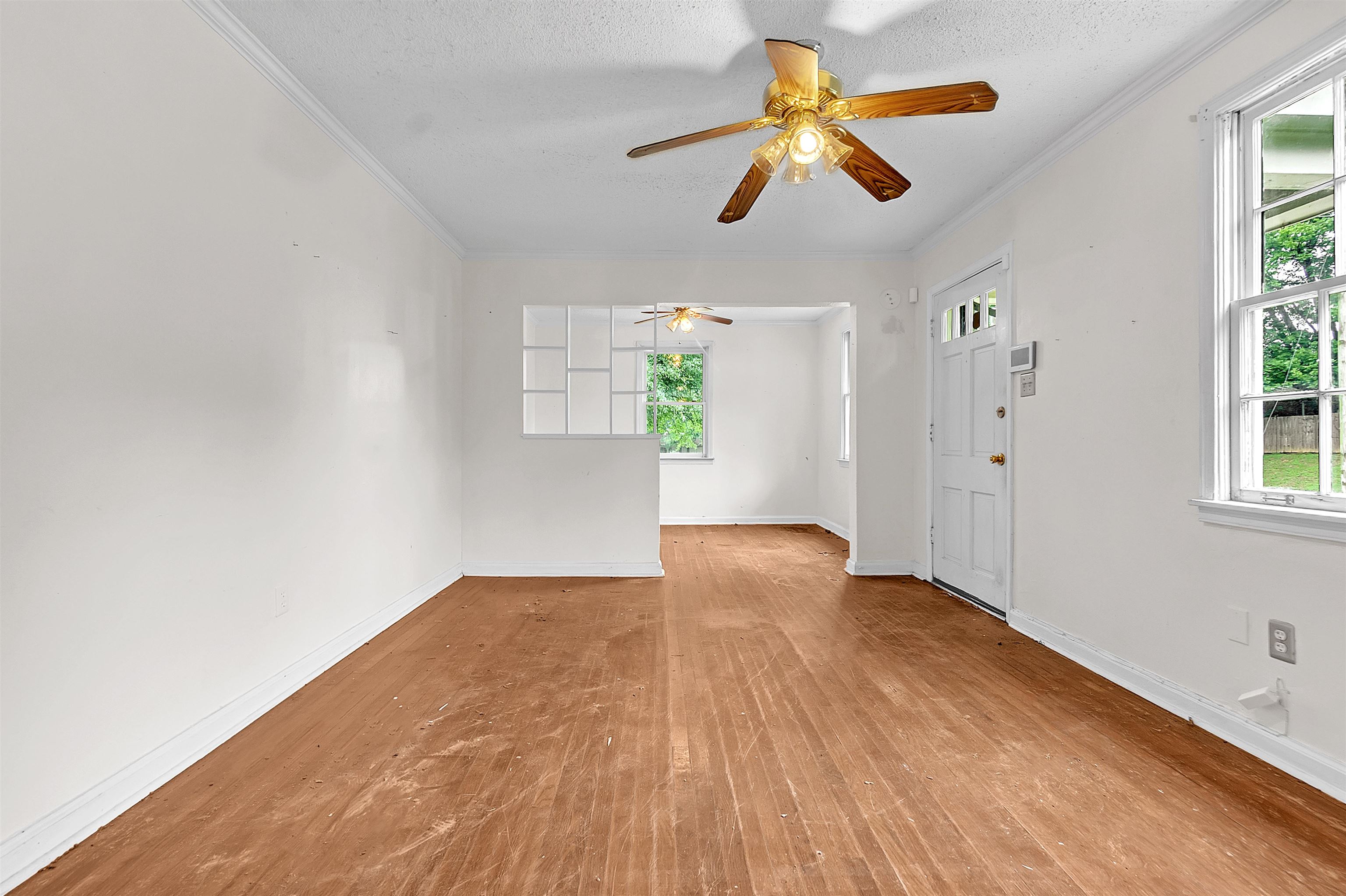1013 Waring Road Memphis, TN 38122 - Photo 3 of 11 a view of empty room with wooden floor and fan