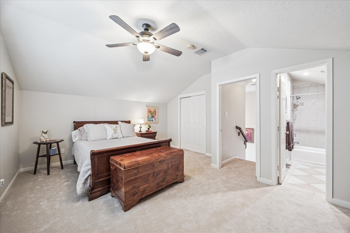 1502 Adkins Road Houston, TX 77055 - Photo 20 of 35 a bedroom with a bed and a chandelier