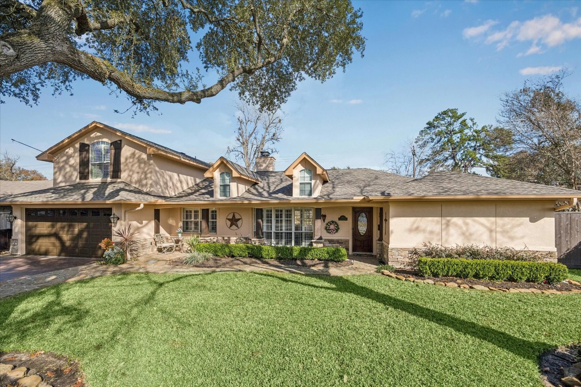 1502 Adkins Road Houston, TX 77055 - Photo 2 of 35 a front view of a house with a garden and plants