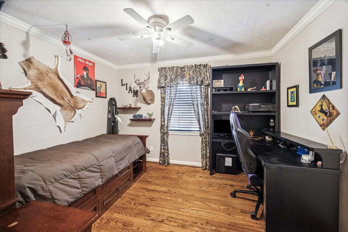1502 Adkins Road Houston, TX 77055 - Photo 24 of 35 a bedroom with furniture and a chandelier