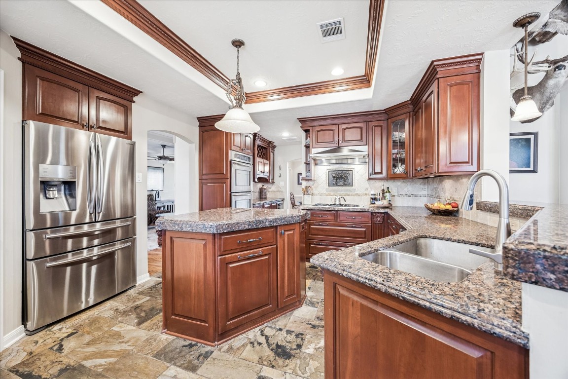 1502 Adkins Road Houston, TX 77055 - Photo 6 of 35 a kitchen with stainless steel appliances granite countertop a sink stove and refrigerator