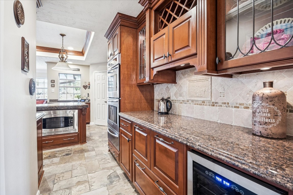 1502 Adkins Road Houston, TX 77055 - Photo 8 of 35 a kitchen with stainless steel appliances granite countertop a stove and cabinets