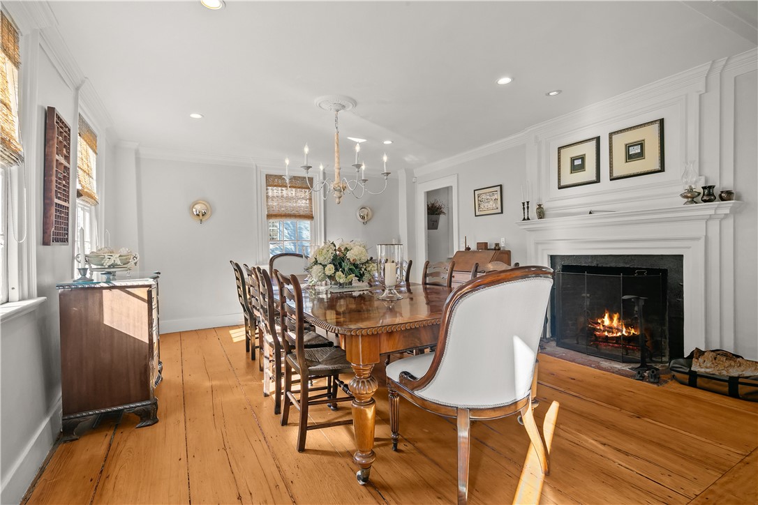 70 Mill Street Newport, RI 02840 - Photo 17 of 50 Spacious dining room with wood burning oven and wide plank original pine floors. Great natural light. Rare opportunity to have a large dining table in an original colonial home.