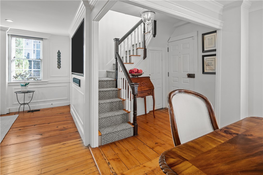 70 Mill Street Newport, RI 02840 - Photo 21 of 50 Entry door is to the right with door to basement just to the left. Coat closet and storage is located on the other side of the television.
