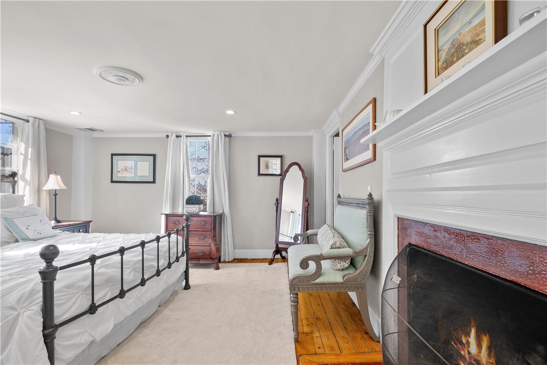 70 Mill Street Newport, RI 02840 - Photo 26 of 50 Large primary bedroom with king bed. Original pine floors.