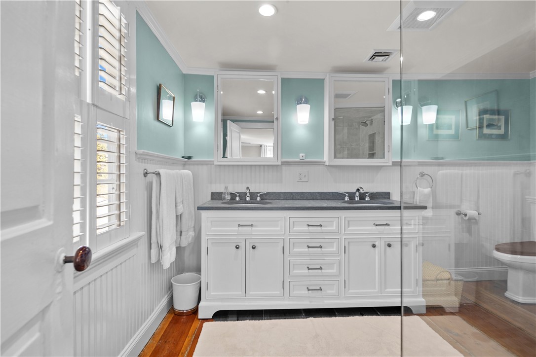 70 Mill Street Newport, RI 02840 - Photo 29 of 50 Primary bathroom was recently updated with double sink vanity, large shower and linen closet.