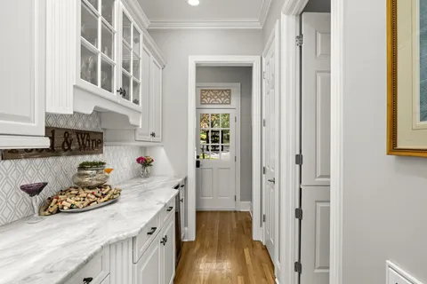 a kitchen with granite countertop lots of counter top space and wooden floor