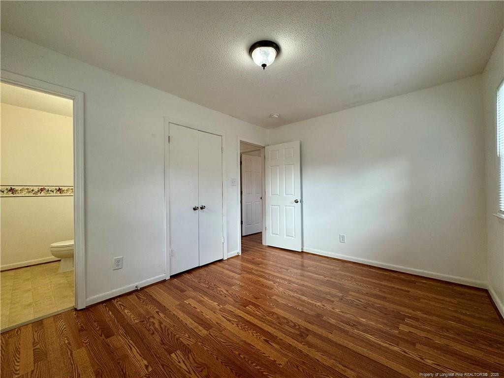703 Odell Road Spring Lake, NC 28390 - Photo 11 of 21 a view of an empty room with wooden floor