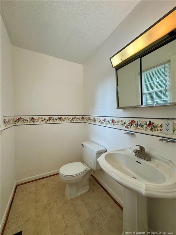 703 Odell Road Spring Lake, NC 28390 - Photo 12 of 21 a bathroom with a sink and a toilet