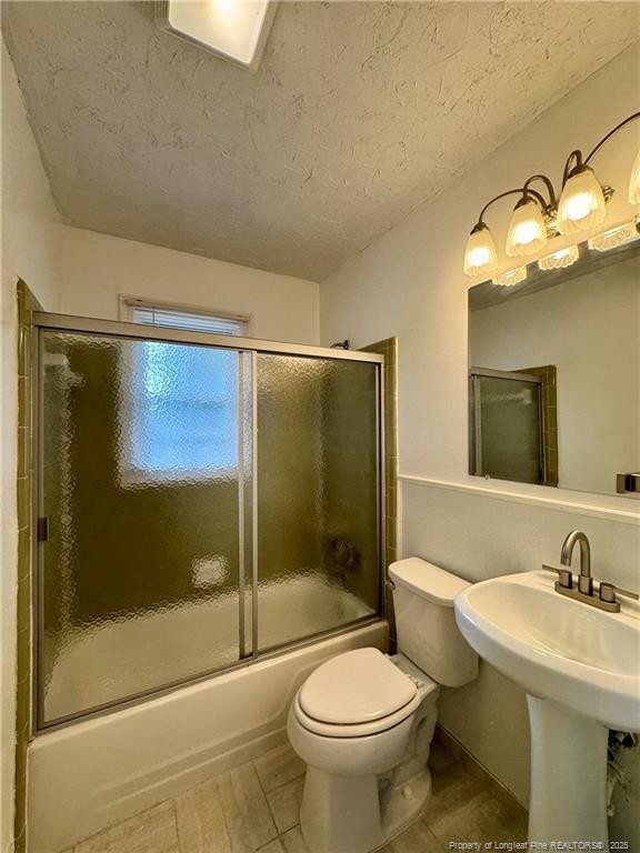 703 Odell Road Spring Lake, NC 28390 - Photo 15 of 21 a bathroom with a sink toilet and shower