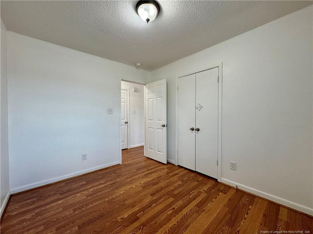 703 Odell Road Spring Lake, NC 28390 - Photo 17 of 21 a view of an empty room with wooden floor
