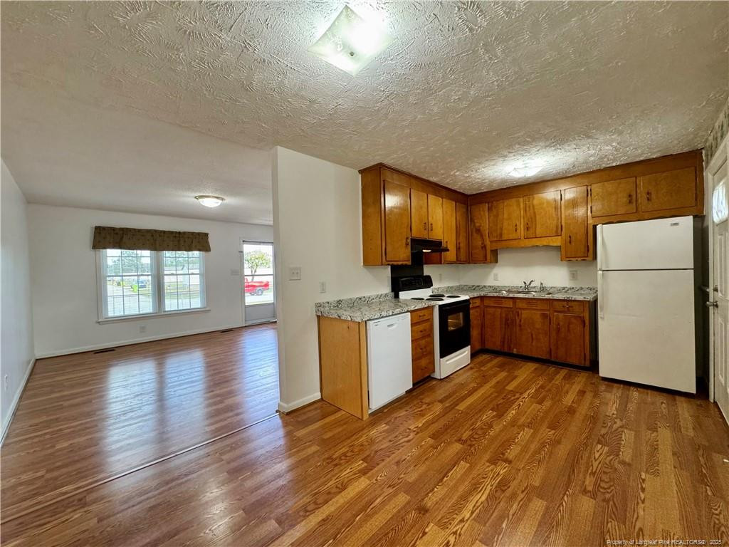 703 Odell Road Spring Lake, NC 28390 - Photo 6 of 21 a kitchen with a refrigerator a sink and cabinets