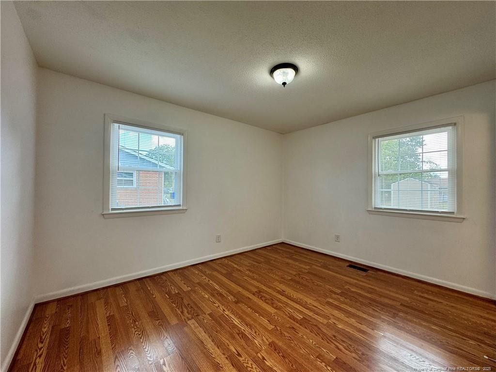 703 Odell Road Spring Lake, NC 28390 - Photo 10 of 21 a view of a room with wooden floor and windows