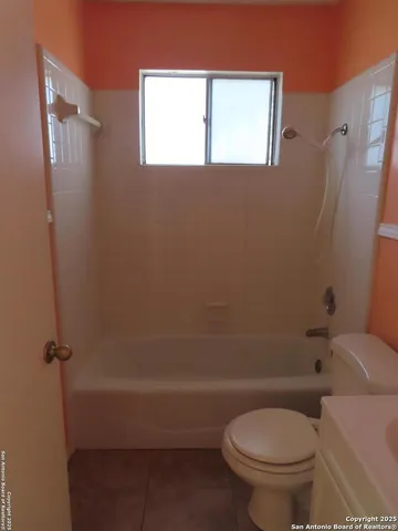 a bathroom with a toilet a sink and shower