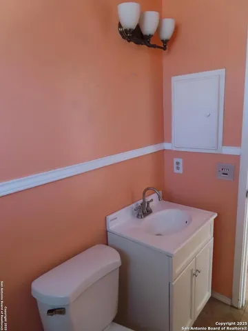 a bathroom with a sink a toilet and a mirror