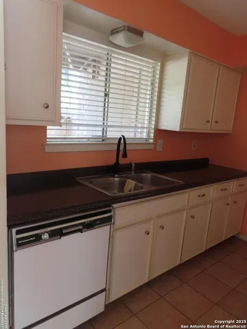 a kitchen with granite countertop a sink and a stove
