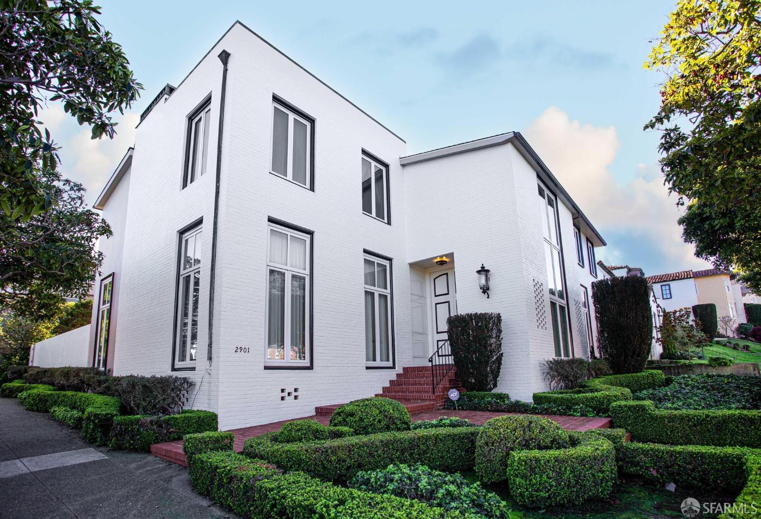 a front view of a house with garden