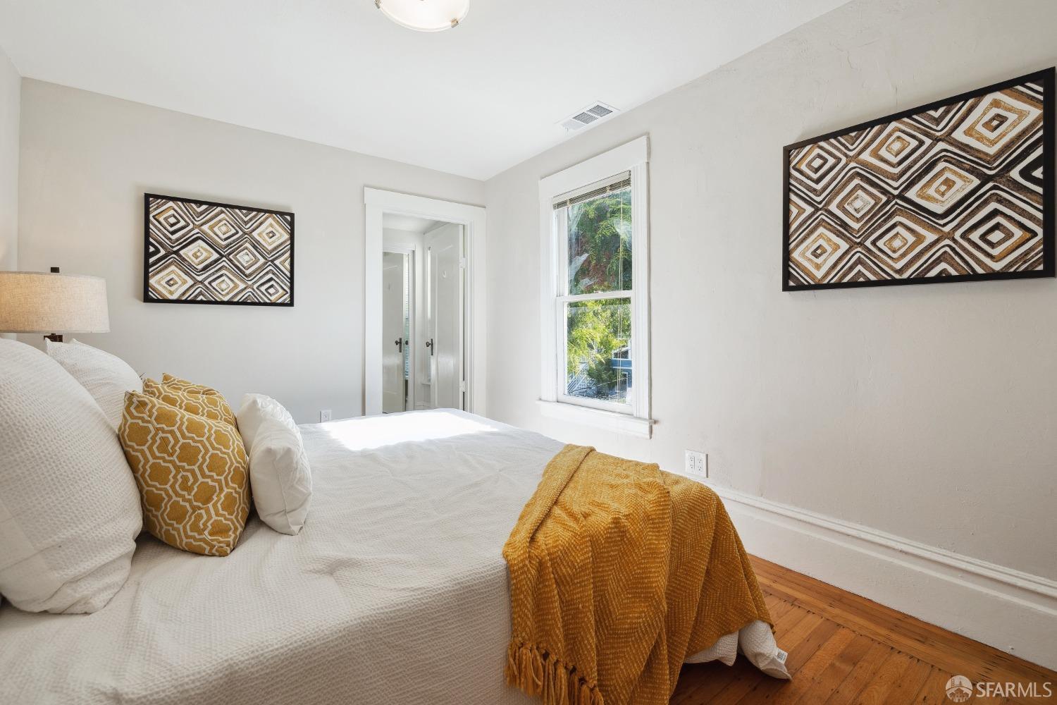 1817 Woolsey Street Berkeley, CA 94703 - Photo 20 of 35 a bedroom with a bed and a window