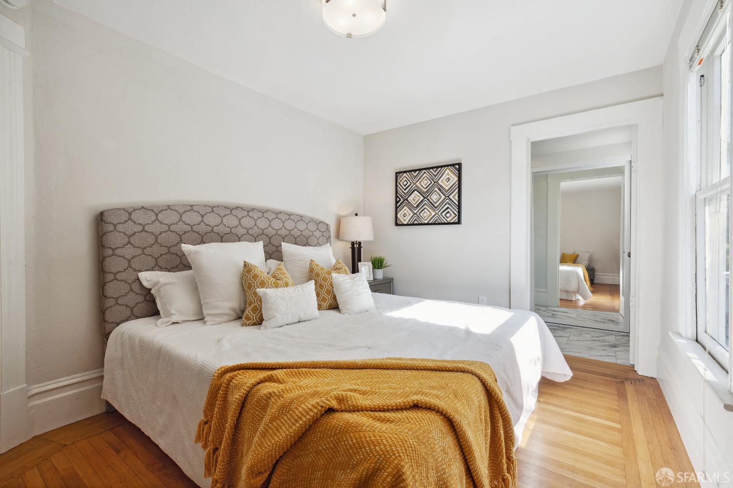 1817 Woolsey Street Berkeley, CA 94703 - Photo 21 of 35 a bedroom with a bed and a lamp