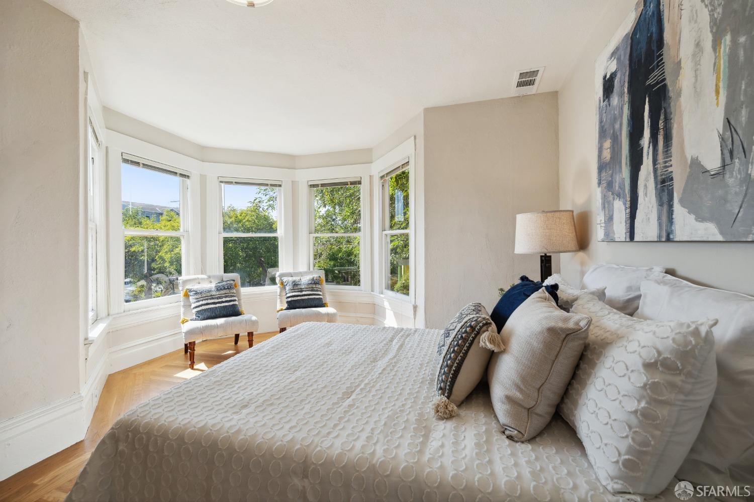 1817 Woolsey Street Berkeley, CA 94703 - Photo 27 of 35 a bed sitting in a bedroom next to a window