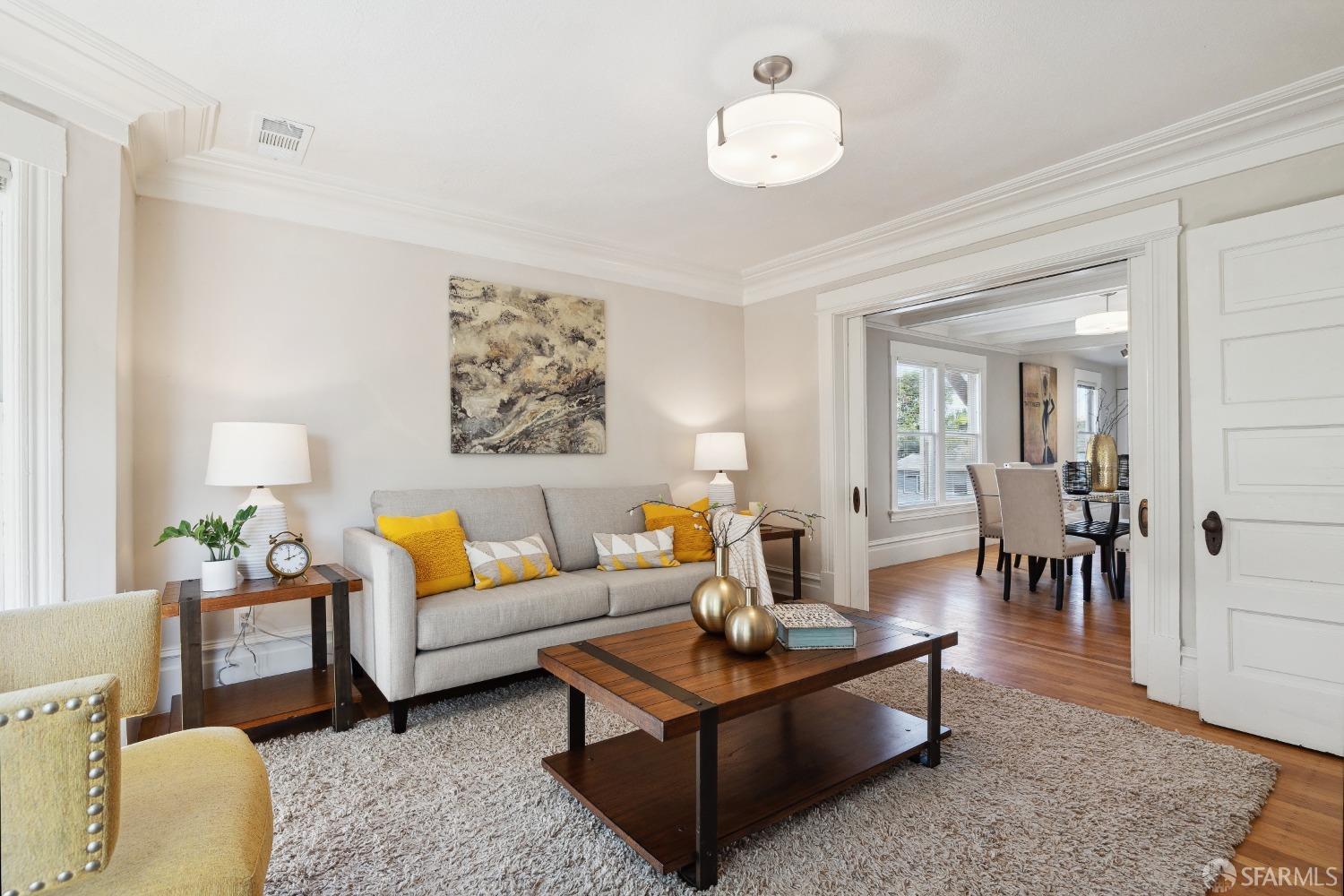 1817 Woolsey Street Berkeley, CA 94703 - Photo 9 of 35 a living room with furniture wooden floor and a chandelier