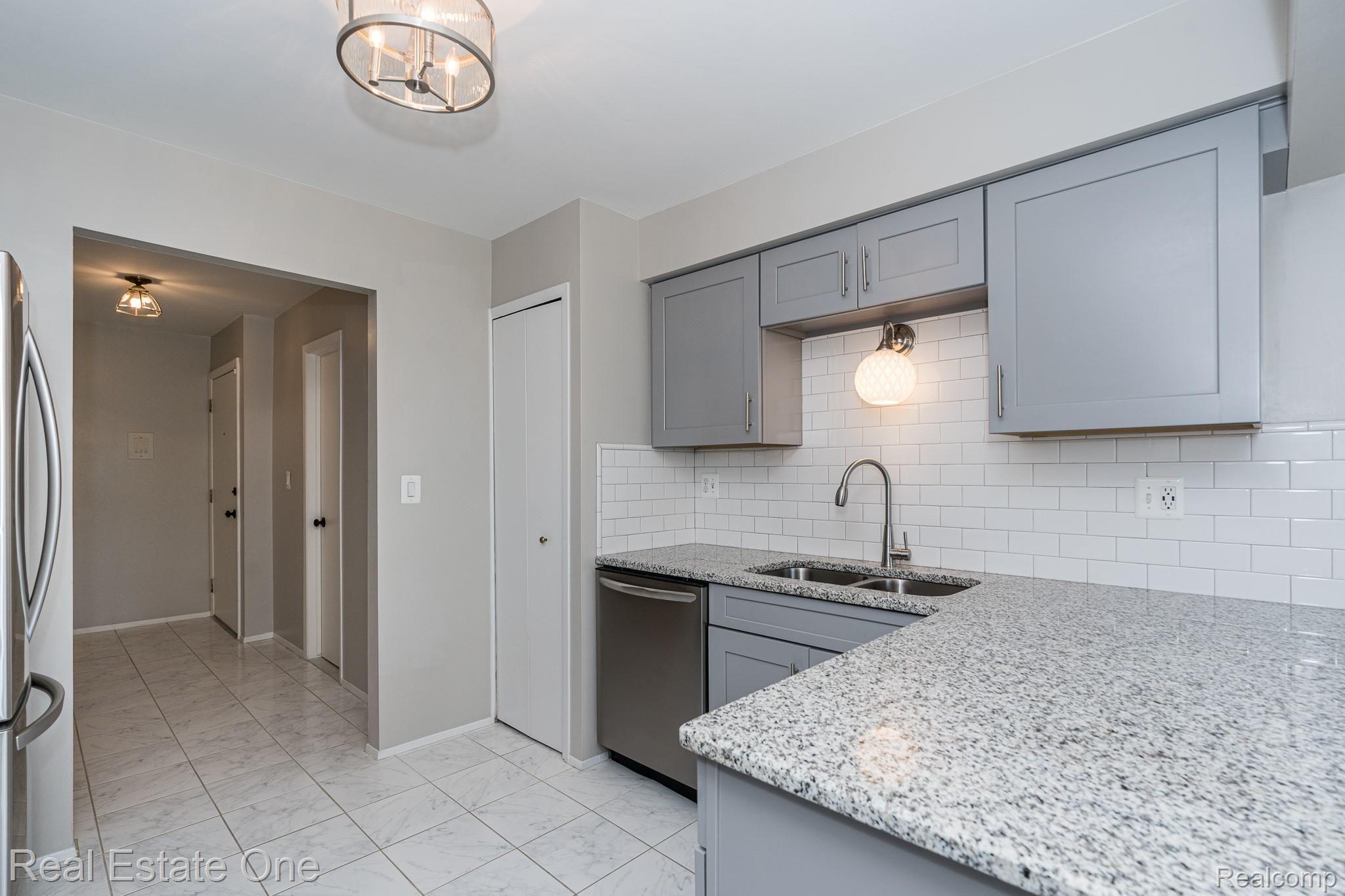 1677 Riverside Drive, Unit 16 Rochester, MI 48309 - Photo 3 of 31 GRANITE COUNTERS AND MODERN SHAKER CABINETS WITH SOFT CLOSE / SELF CLOSE DOORS & DRAWERS - FULL HEIGHT PANTRY - 1677 Riverside MLS-W008.jpg