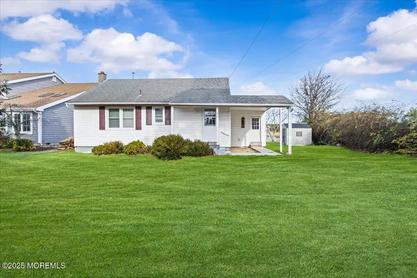 a front view of house with yard and green space