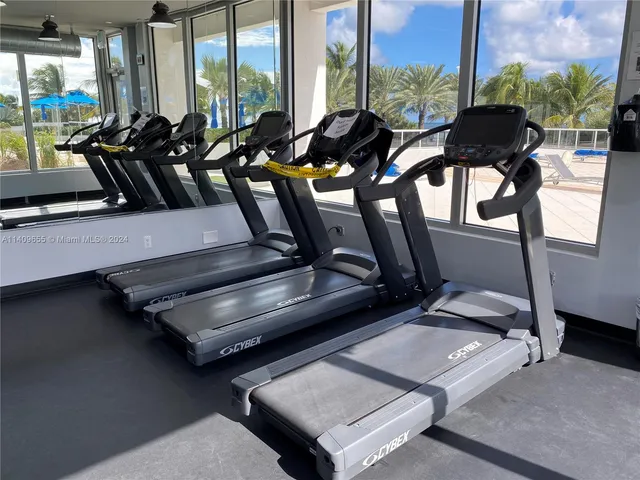 a room with gym equipment and a large window
