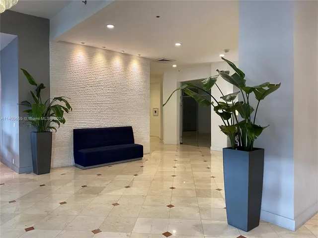 a room with a couch and a potted plant