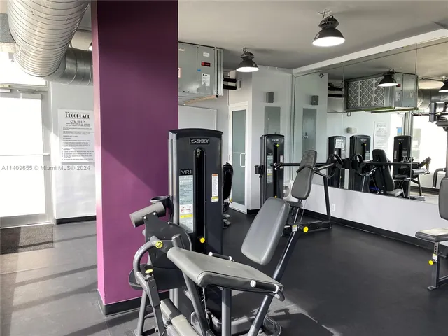 a living room with furniture a flat screen tv and a bookshelf