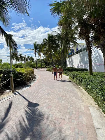 a row of palm trees in front of a building