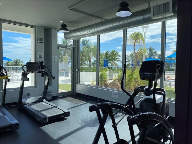 a room with gym equipment and a large window