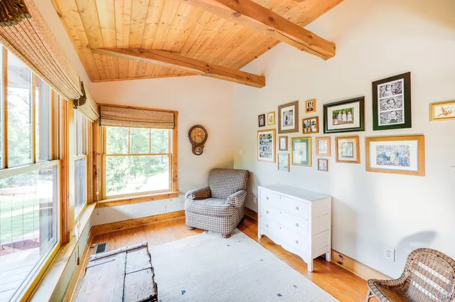 a view of a yard in front of a house with large trees