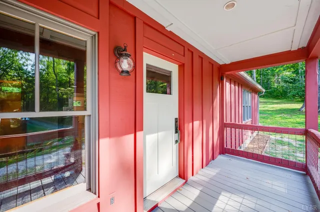 a bedroom with a bed and a dresser next to a window