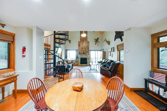 a view of a hallway with wooden floor and stairs