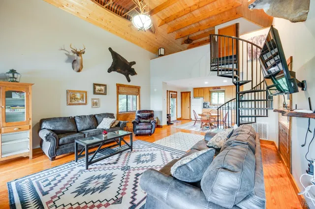 a view of a kitchen with furniture and wooden floor
