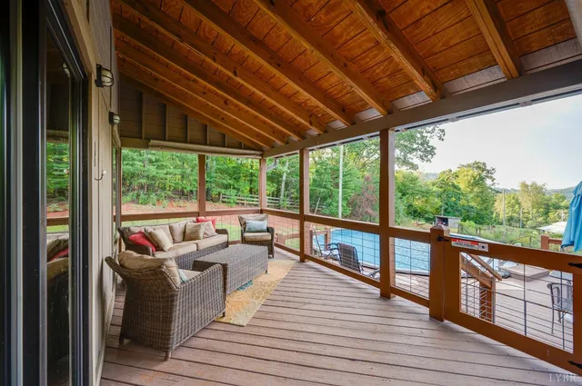 a swimming pool with outdoor seating and yard