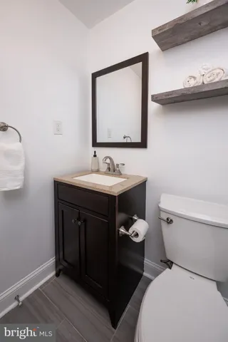 a bathroom with a toilet a sink and mirror