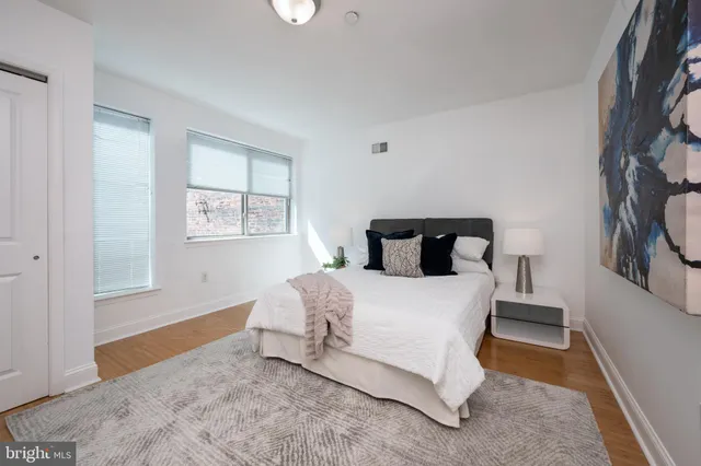 a bed sitting in a bedroom next to a window